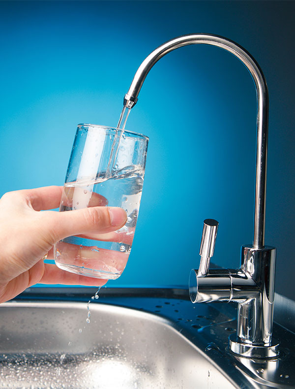 Hand Pouring Water from Filter Tap Hand Pouring Water from Filter Tap
