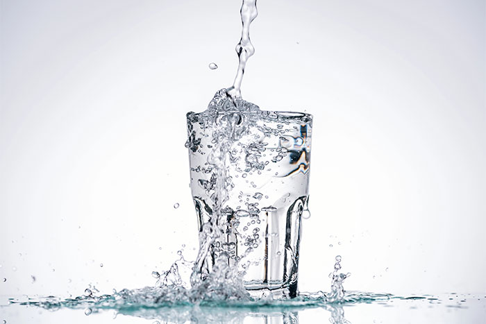 Water pouring in Full Glass